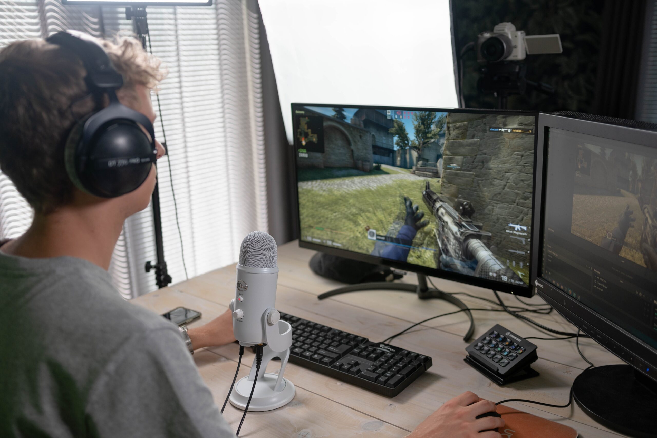 image of a male gamer playing games and also live streaming for e-sports activity